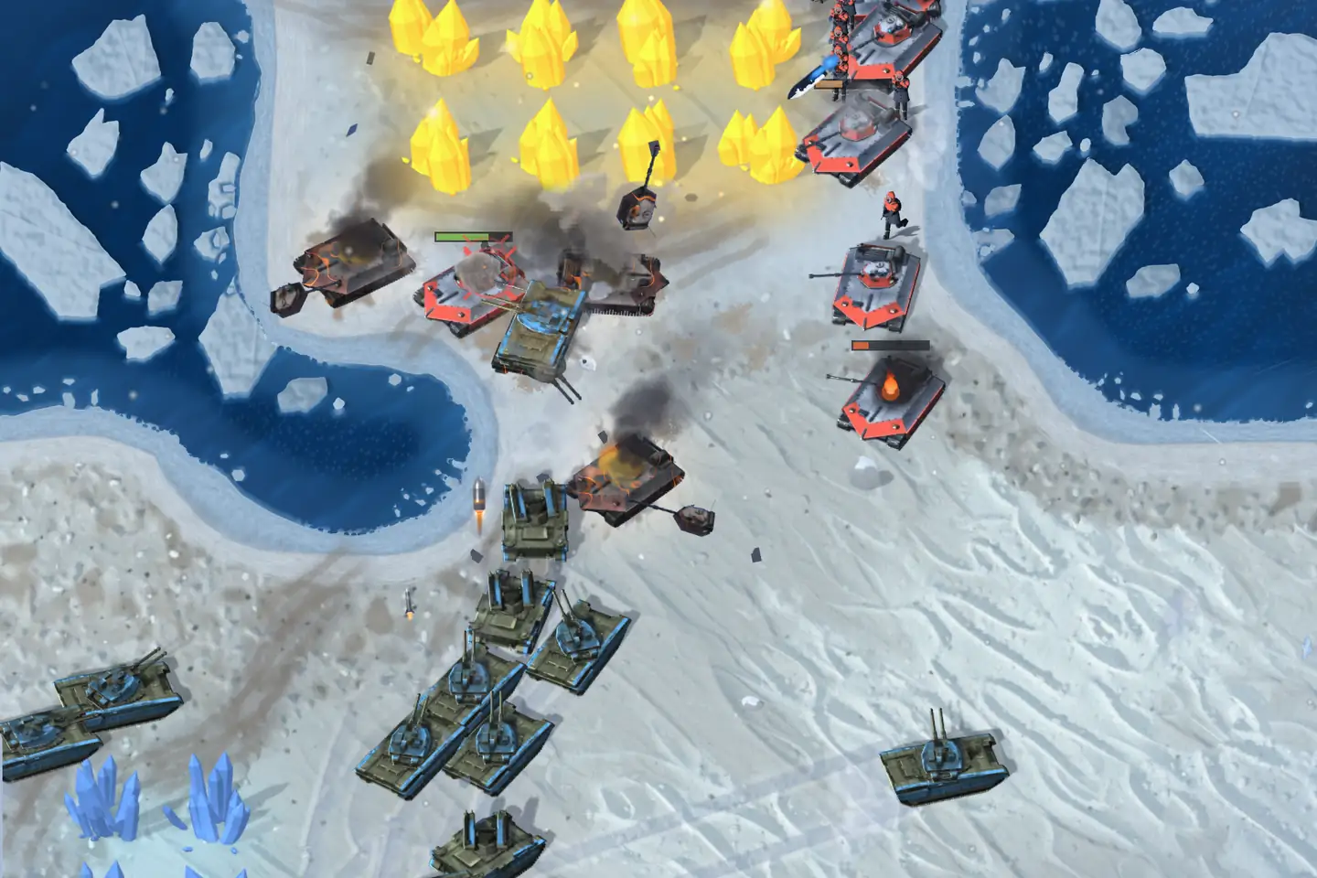 A battle on an icy shore, seen from above. A column of olive tanks with blue trim climbs the snow from the lower left toward a field of glowing gold crystals, where white tanks with red armour plates and red-suited infantry hold the ground. Burning hulks smoke between them, and dark blue water full of white ice floes runs along both sides.