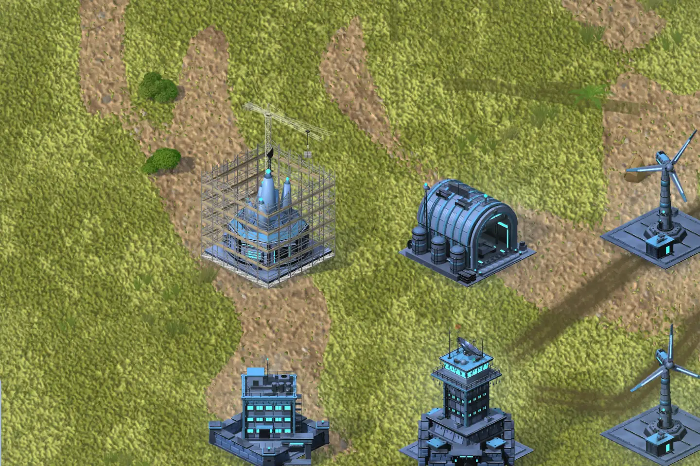 A FROST base on green grassland crossed by worn dirt tracks, seen from above. Left of centre a spired building rises inside a steel scaffold with a construction crane standing over it. Around it stand a finished hangar with a ribbed roof, a tall tower with a radar dish, a block with rows of lit windows and two wind turbines at the right edge, all dark steel picked out in cyan light.