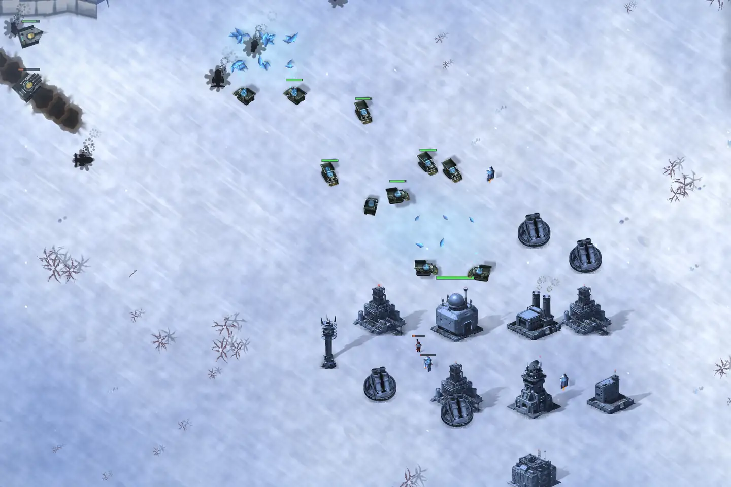 A base on a snowfield with its army above it: grey-steel buildings laid out in rows — one under a radar dome, one with two chimney stacks, a lattice mast, a low blockhouse and four squat dark gun emplacements — each throwing a long shadow. A dozen olive-marked tanks stand between the base and a patch of blue crystal ore at the centre of the frame, health bars over them. Something is burning off the top-left corner, trailing smoke.